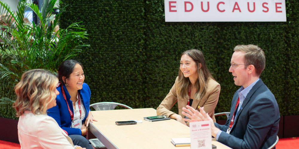 4 people talking at a table.