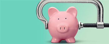 Pink pig piggy bank with a vise squeezing it.