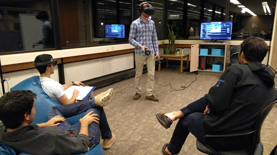 1 student using XR equipment while 3 others watch