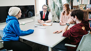 4 people sitting around a table