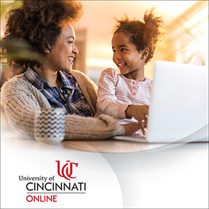 Mother and child in front of a laptop. University of Cincinnati Online.