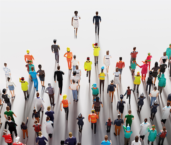 2 people walking forward with a crowd of people following