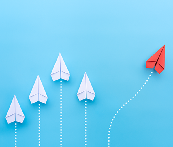 Four white paper airplanes flying in a straight line. One red paper airplane flying away at an angle.